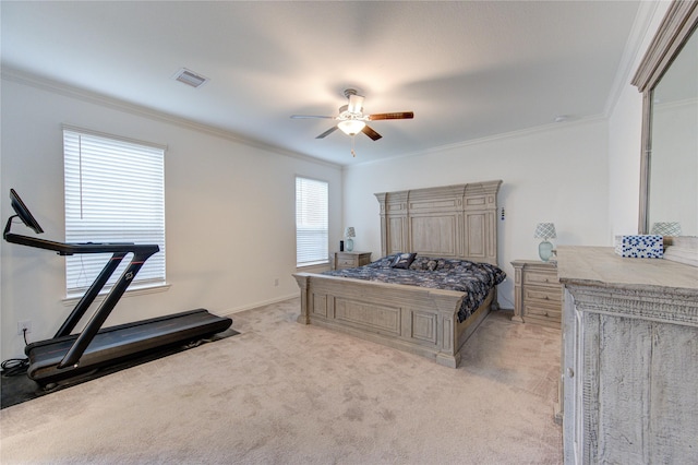 carpeted bedroom featuring ceiling fan, crown molding, and multiple windows