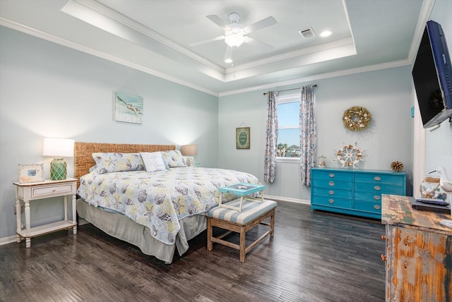 bedroom featuring dark hardwood / wood-style floors, a raised ceiling, ceiling fan, and ornamental molding