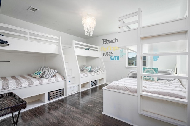 bedroom with an inviting chandelier and dark wood-type flooring