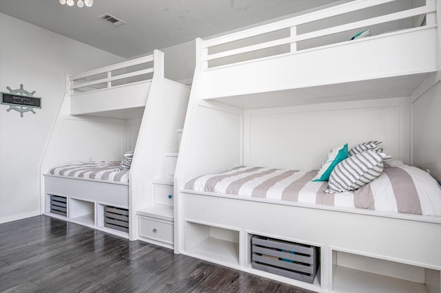 bedroom with dark hardwood / wood-style flooring