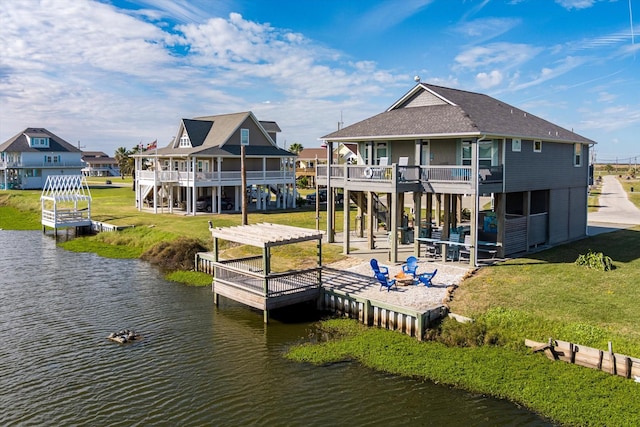 back of house featuring a pergola, a water view, a balcony, and a patio