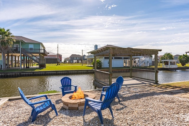 dock area featuring a water view and an outdoor fire pit