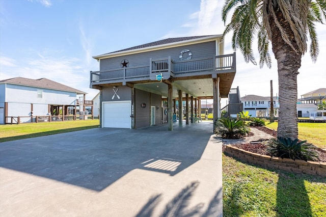 view of front of house with a balcony, a garage, and a carport