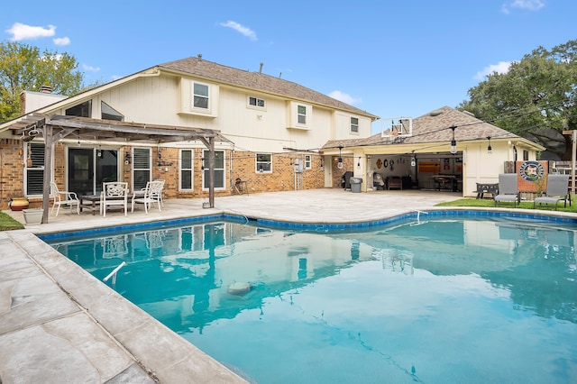 view of pool with a patio and a pergola