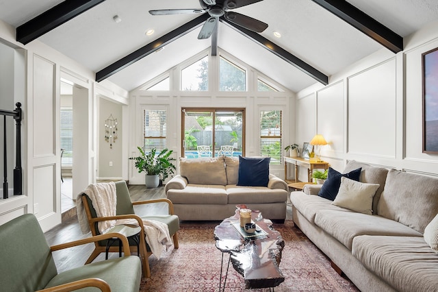 living room featuring ceiling fan, hardwood / wood-style floors, beamed ceiling, and high vaulted ceiling