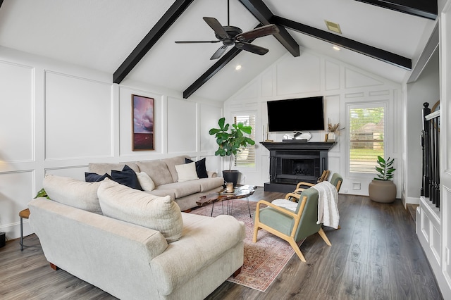 living room with plenty of natural light, beam ceiling, wood-type flooring, and ceiling fan