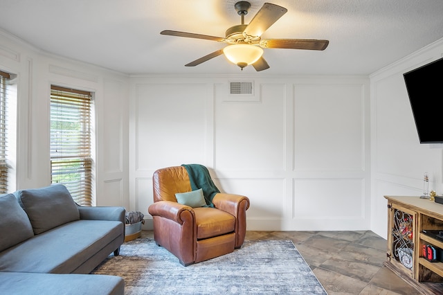 living room with a textured ceiling and ceiling fan