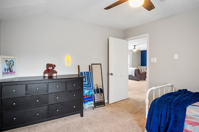 carpeted bedroom with vaulted ceiling and ceiling fan