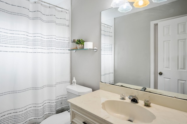 bathroom featuring vanity and toilet