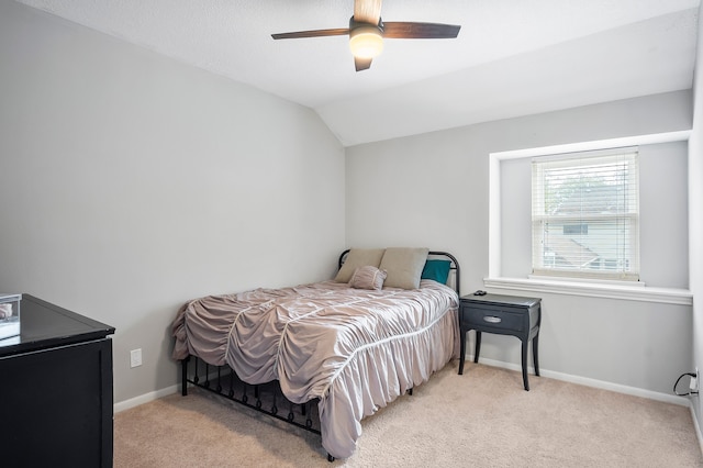 carpeted bedroom featuring vaulted ceiling and ceiling fan