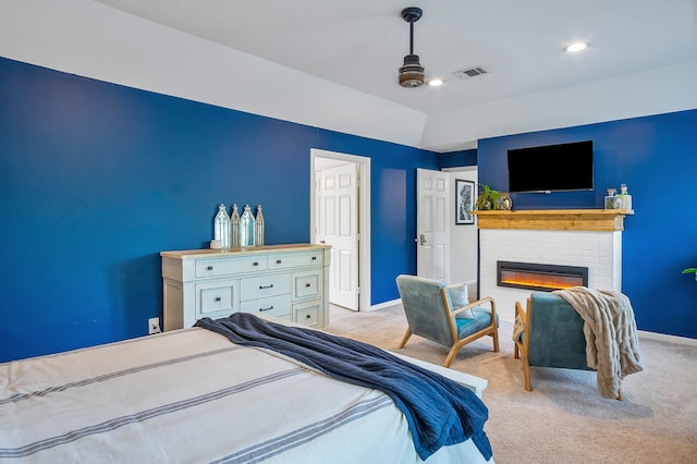 carpeted bedroom featuring ceiling fan, a fireplace, and vaulted ceiling