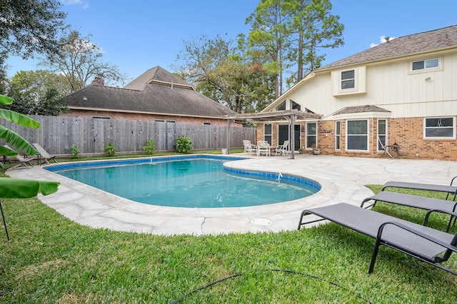 view of pool featuring a yard and a patio