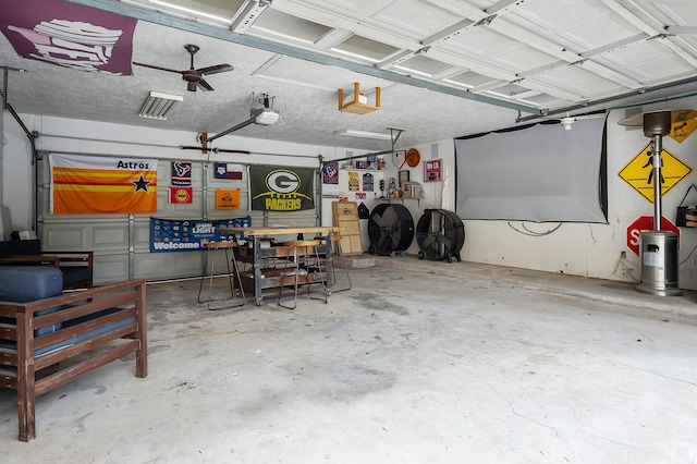 garage with ceiling fan and a garage door opener