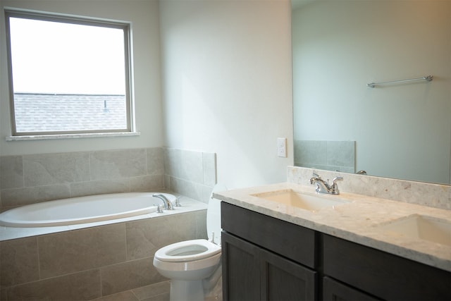 bathroom featuring tile patterned floors, tiled bath, vanity, and toilet