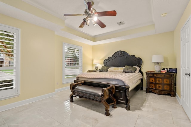 bedroom featuring ceiling fan, a raised ceiling, and crown molding