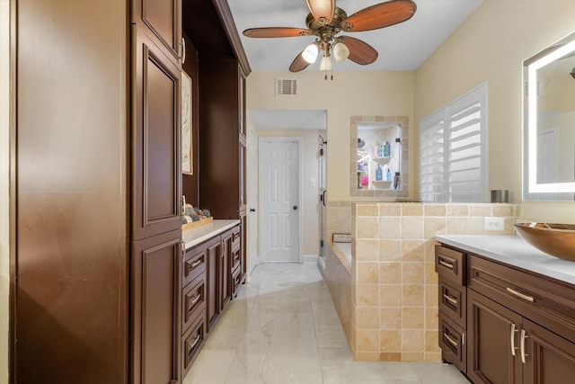 bathroom with ceiling fan, an enclosed shower, and vanity