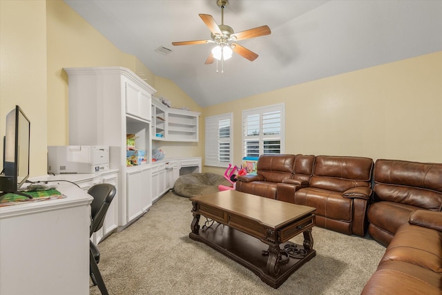 carpeted living room with vaulted ceiling and ceiling fan