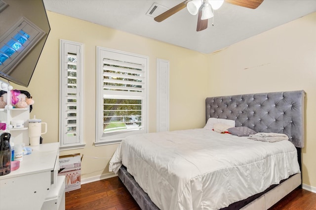 bedroom with ceiling fan and dark hardwood / wood-style flooring