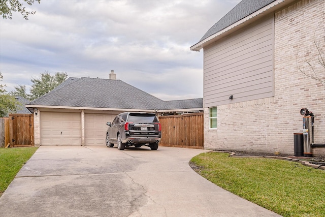 view of property exterior with a garage and a lawn