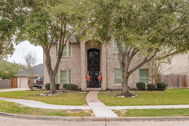 view of front of home featuring a garage and a front yard