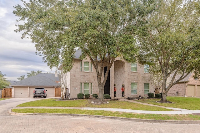 view of front of home with a front yard and a garage