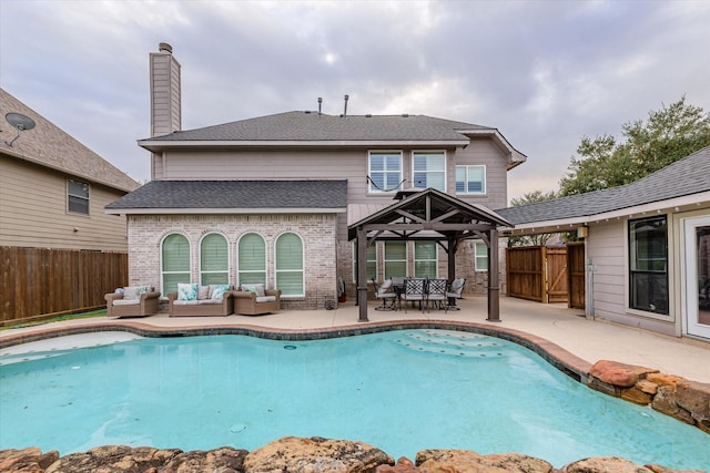 view of swimming pool featuring outdoor lounge area, a gazebo, and a patio