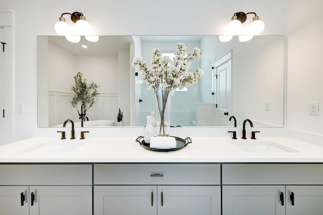 bathroom with vanity and a bath