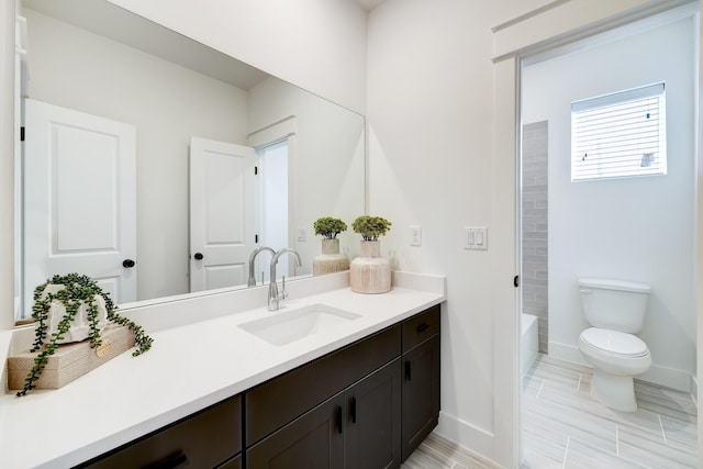 full bathroom with bathtub / shower combination, vanity, and toilet