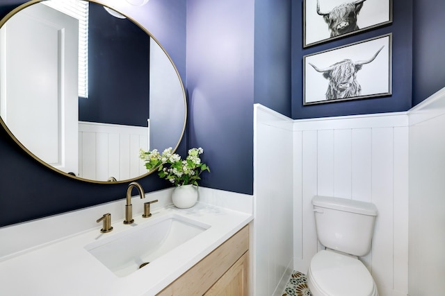 bathroom featuring tile patterned floors, vanity, and toilet