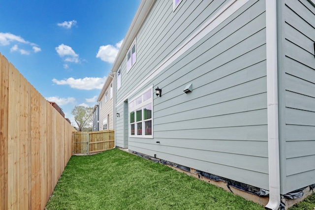 view of side of property with a yard