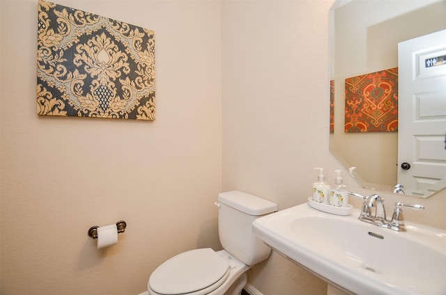 bathroom featuring sink and toilet