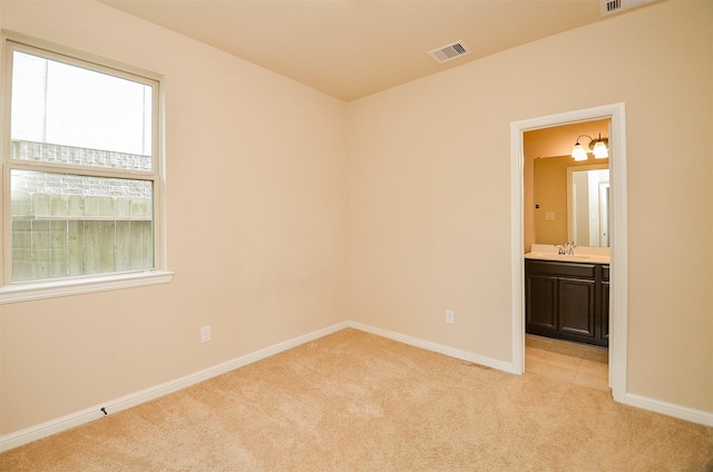 carpeted spare room with sink