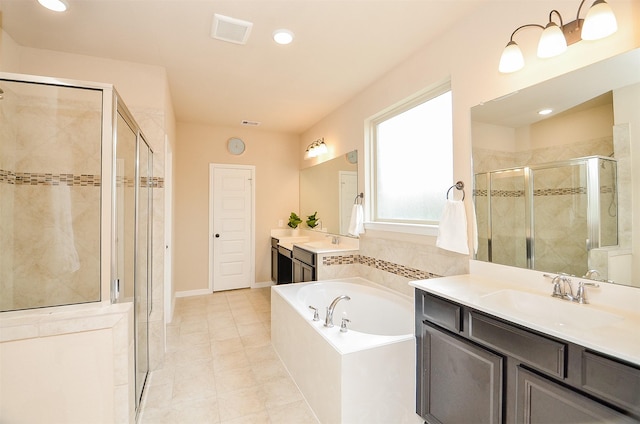 bathroom with tile patterned floors, vanity, and plus walk in shower