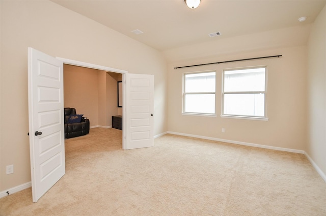 unfurnished bedroom with lofted ceiling and light carpet