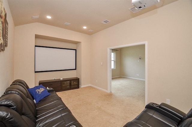 home theater featuring light carpet and lofted ceiling