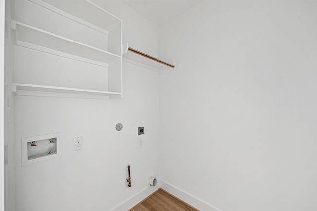 clothes washing area with hookup for a gas dryer, wood-type flooring, washer hookup, and electric dryer hookup