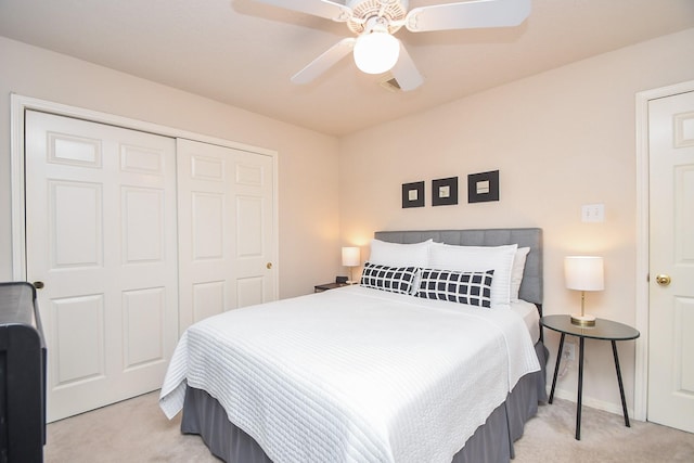 carpeted bedroom with ceiling fan and a closet