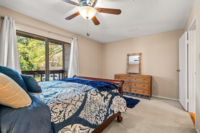 bedroom featuring access to outside, ceiling fan, and a textured ceiling