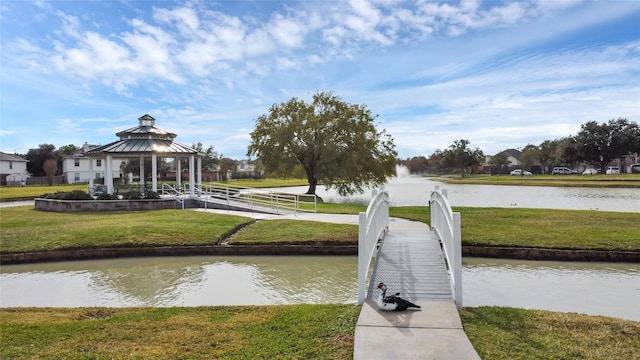 dock area featuring a gazebo, a lawn, and a water view