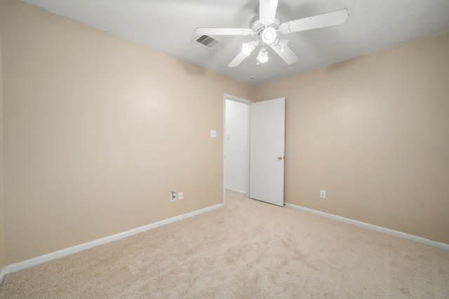 empty room with light colored carpet and ceiling fan