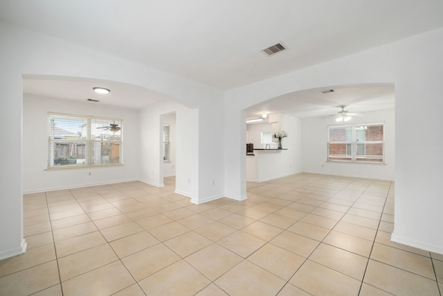 unfurnished living room with ceiling fan and light tile patterned floors