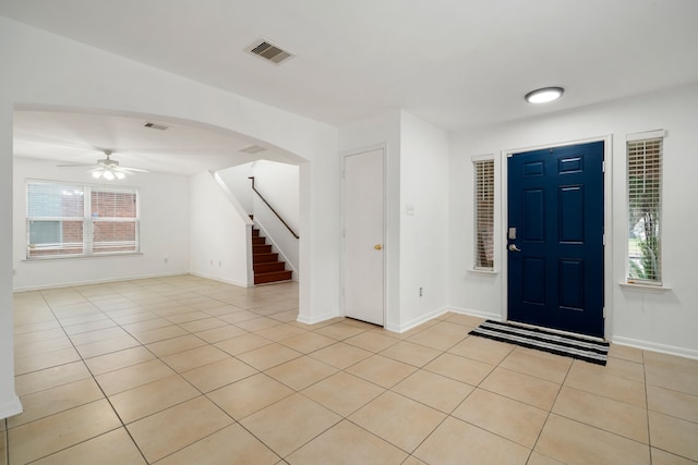 foyer featuring ceiling fan and light tile patterned flooring