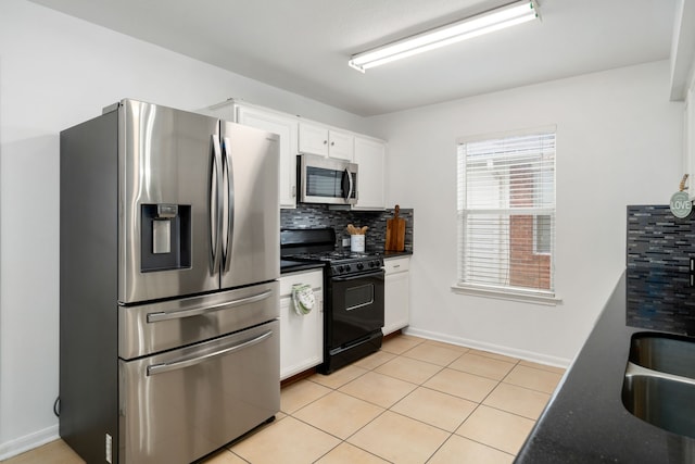 kitchen featuring decorative backsplash, white cabinets, stainless steel appliances, and light tile patterned floors