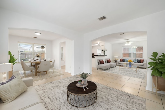 living room with ceiling fan and light tile patterned floors