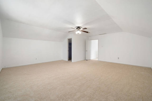 bonus room featuring ceiling fan, light colored carpet, and lofted ceiling