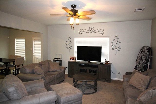 living room with carpet floors, ceiling fan, and a healthy amount of sunlight