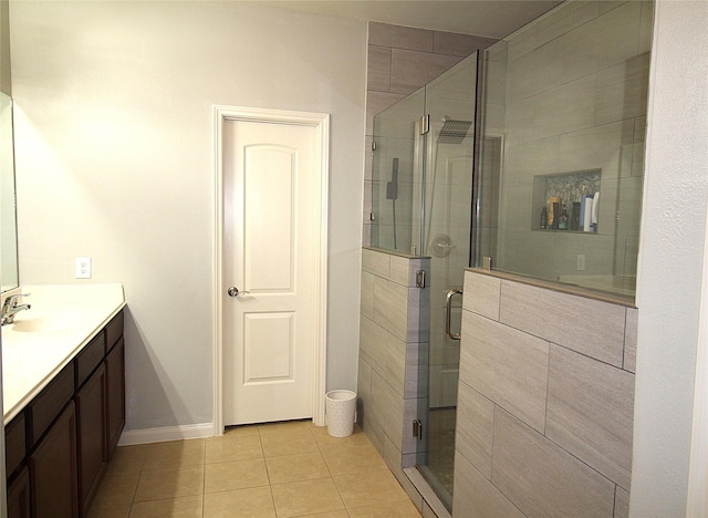 bathroom featuring tile patterned flooring, vanity, and a shower with door