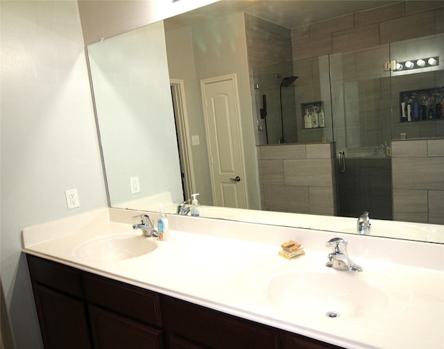 bathroom featuring vanity and an enclosed shower