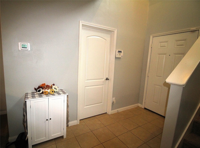 hall featuring light tile patterned flooring