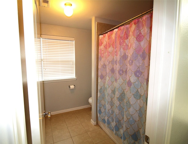 bathroom with toilet, a shower with curtain, and tile patterned floors